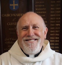 A white man wearing a clerical collar
